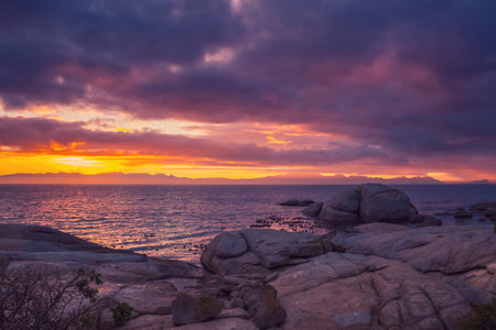 View of a cloudy sunrise from Boulders beach with a view of False Bay, Simon's Town, Cape Town, South Africaの写真素材