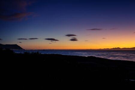 View of a cloudy sunrise from Boulders beach with a view of False Bay, Simon's Town, Cape Town, South Africaの写真素材