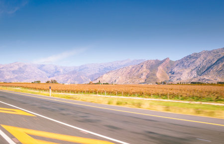 Beautiful mountainous landscape from a moving car driving on a tar road, Cape Town, South Africaの写真素材