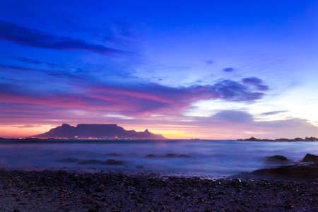 View of Table Mountain at sunrise, Cape Town, South Africa from Milnerton Beach coastlineの写真素材