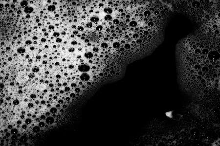 High contrast Black and white macro photography texture backgrounds, soapy bubbles in waterの写真素材