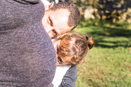 Maternity photo shoot, a father and pregnant mother, with their young daughter with curly brown having fun, Cape Town, South Africaの写真素材