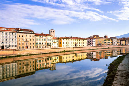 View of the river Arno lined with colorful buildings in the city of Pisa, Pisa, Tuscany, Italy, Europeの写真素材