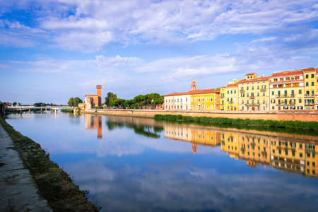 View of the river Arno lined with Santa Maria della Spina church and colorful buildings in the city of Pisa, Pisa, Tuscany, Italy, Europeの写真素材