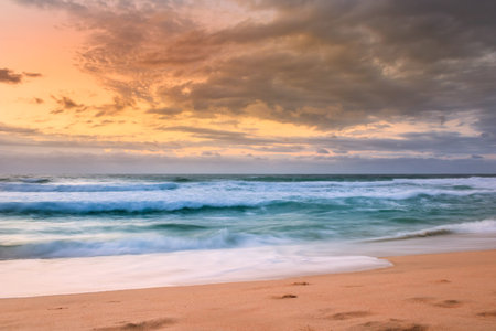 Overcast cloudy sunrise over a rough Indian Ocean from a view point on a beach in Port Shepstone,...
