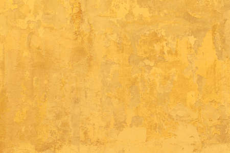 Vintage Grunge yellow plaster Wall Texture. Abstract Painted Wall Surface. Wide Angle Rough Background With Copy Space For designの写真素材