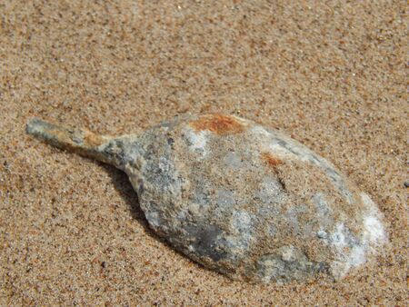 Rusty Spoon in the sandの写真素材