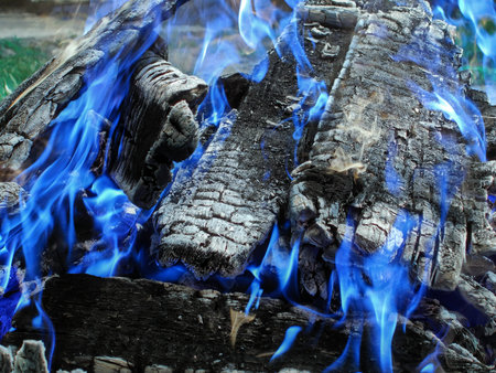 Bonfire with white coals with blue flame