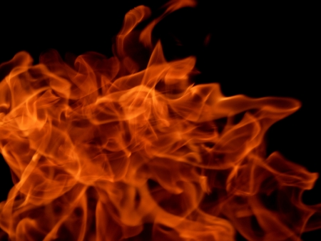 Texture of bright fire flames on a black backgroundの写真素材