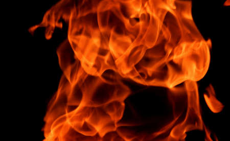 Texture of bright fire flames on a black backgroundの写真素材