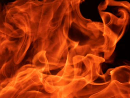 Abstract bright flame of fire on a black backgroundの写真素材