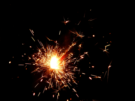 New Year with sparklers sparks on a black background closeupの写真素材