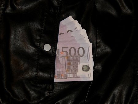 euro money in a pocket of leather jacketの写真素材