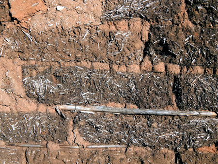 The wall of the barn out of clay and straw