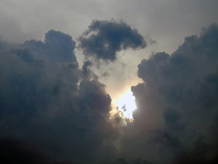 The emergence of the sun from the clouds in the sky close-up