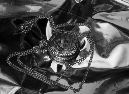 Clock with chain on a chrome background in black and white imageの写真素材