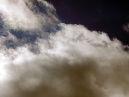 The emergence of the sun from the clouds in the sky close-upの写真素材