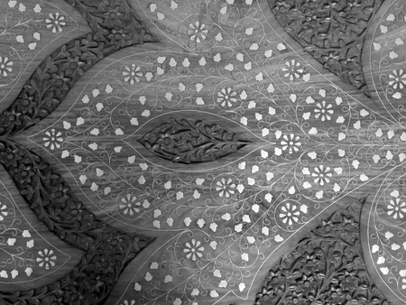 Decorative carvings on the board on a black and white imageの写真素材