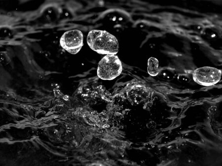 Splashes of water with a splash on a black and white imageの写真素材