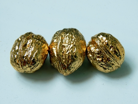 Golden walnuts on a light backgroundの写真素材