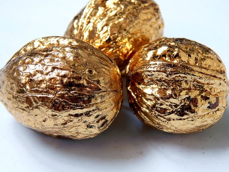 Golden walnuts on a light backgroundの写真素材