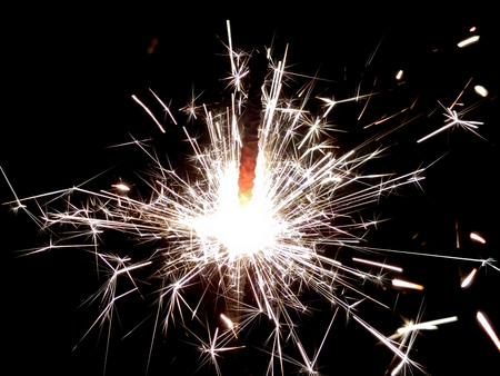 Christmas Bengal lights with bright sparks on a black background closeupの写真素材