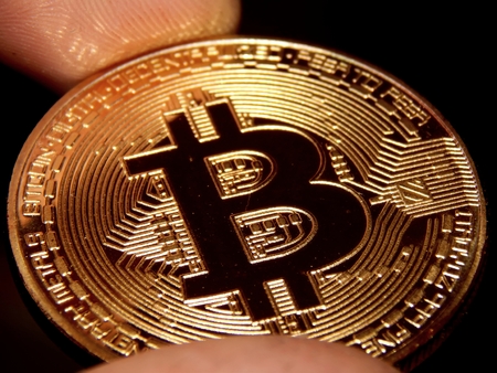 Gold coin bitcoin in handの写真素材