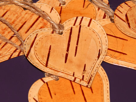 Heart made of birch bark on a purple background. Manual work in designの写真素材
