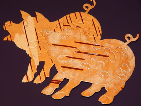 Birch bark pig on a purple background. Manual work in designの写真素材