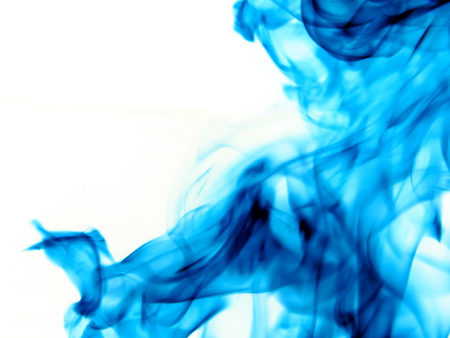 Abstract background of flowing ink in water on a white background.の写真素材