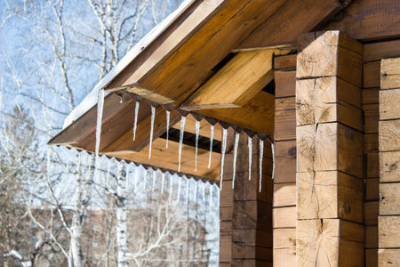 beautiful icicles glint in the sun against the blue sky