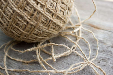 wool ball of threads on wooden tableの写真素材