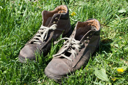 Boots on grass background/A vintage boots on grassの写真素材
