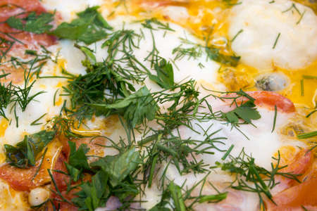 Fried eggs in a pan with vegetables.の写真素材