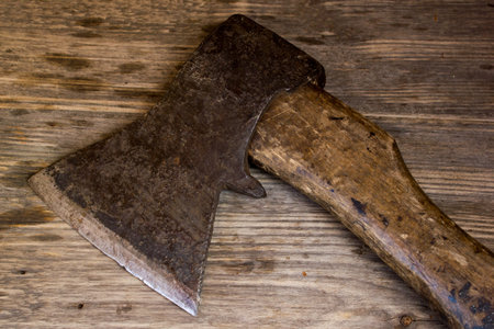 old ax on a wooden background. top view.の写真素材