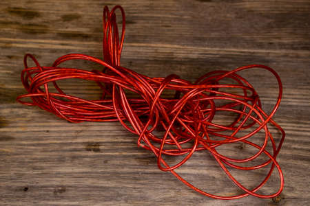 Red Rope and Textured Wood, Coil of ÑÐ¾Ð¿Ðµ set against highly textured wood.の写真素材