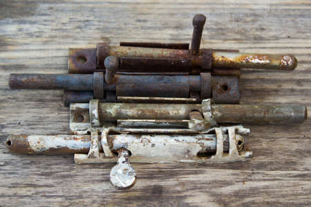 old metal latch for the door on wooden tableの写真素材