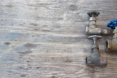 plumber pipes on a grungy wooden backgroundの写真素材