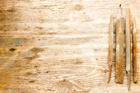 various different steel retro rusty rasp file tool collection isolated on wooden background. Copy space to right.の写真素材