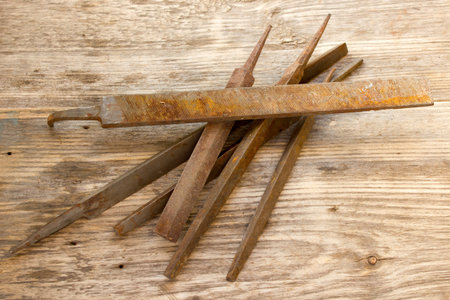 various different steel retro rusty rasp file tool collection isolated on wooden background