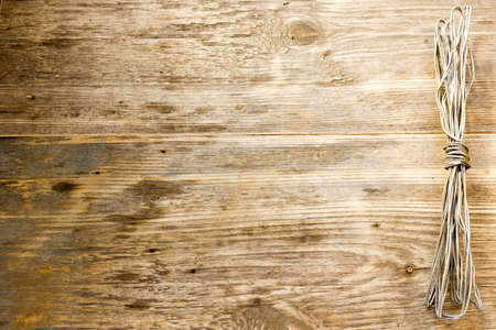 Rope and Textured Wood, Coil of rope set against highly textured wood. Copy space to right.の写真素材