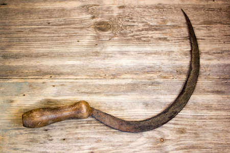 sickle on wooden backgroundの写真素材