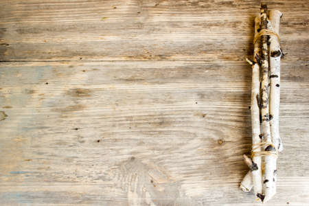 Birch tree trunks and branches on natural wood background. Copy space to right.の写真素材
