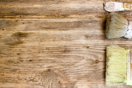 Paint brushes on old wooden background. Copy space to right.の写真素材