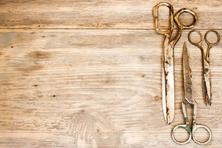 Old scissors on wooden background. Copy space to right.の写真素材