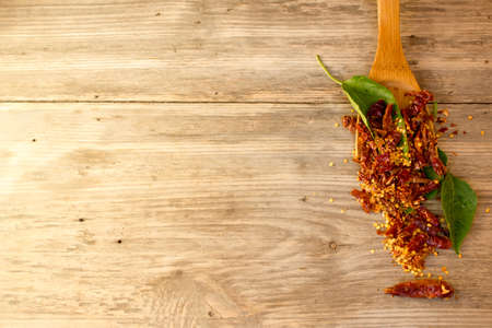 wooden spoon and dried pepper seeds. Copy space to right.の写真素材