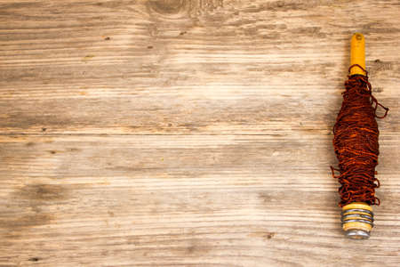 Red Rope and Textured Wood, Coil of white rope set against highly textured wood. Copy space to right.の写真素材