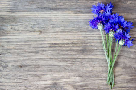 cornflowers on the old wooden table, rustic with copy spaceの写真素材