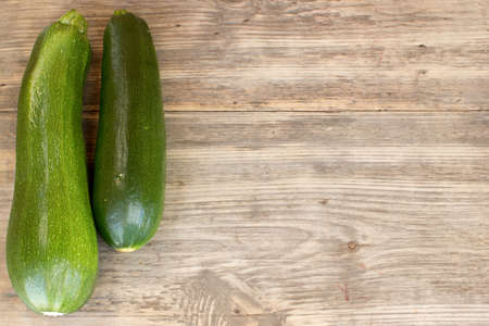 zucchinis on wood background with copy spaceの写真素材