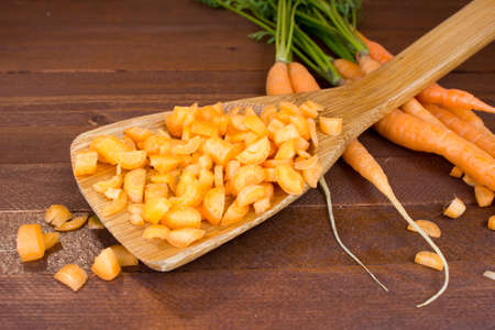 Freshly washed whole carrots on old wooden table. Copy space to right.の写真素材